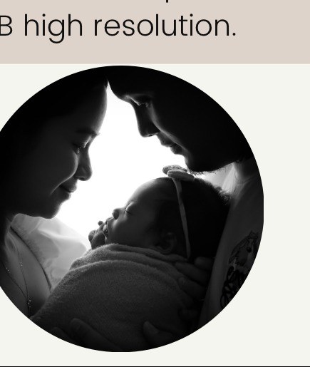 Silhouette of parents kissing their newborn baby